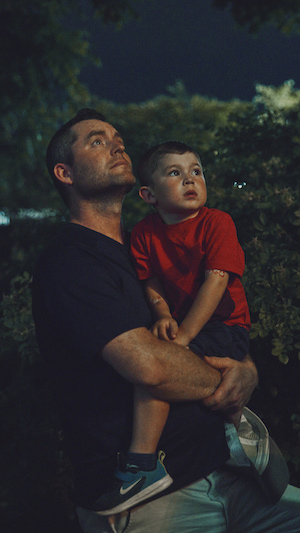 A Father holding his son enjoying the fireworks at Canada Day