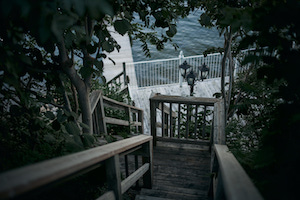 A wood stair surrounded by leaves at Lake Simcoe